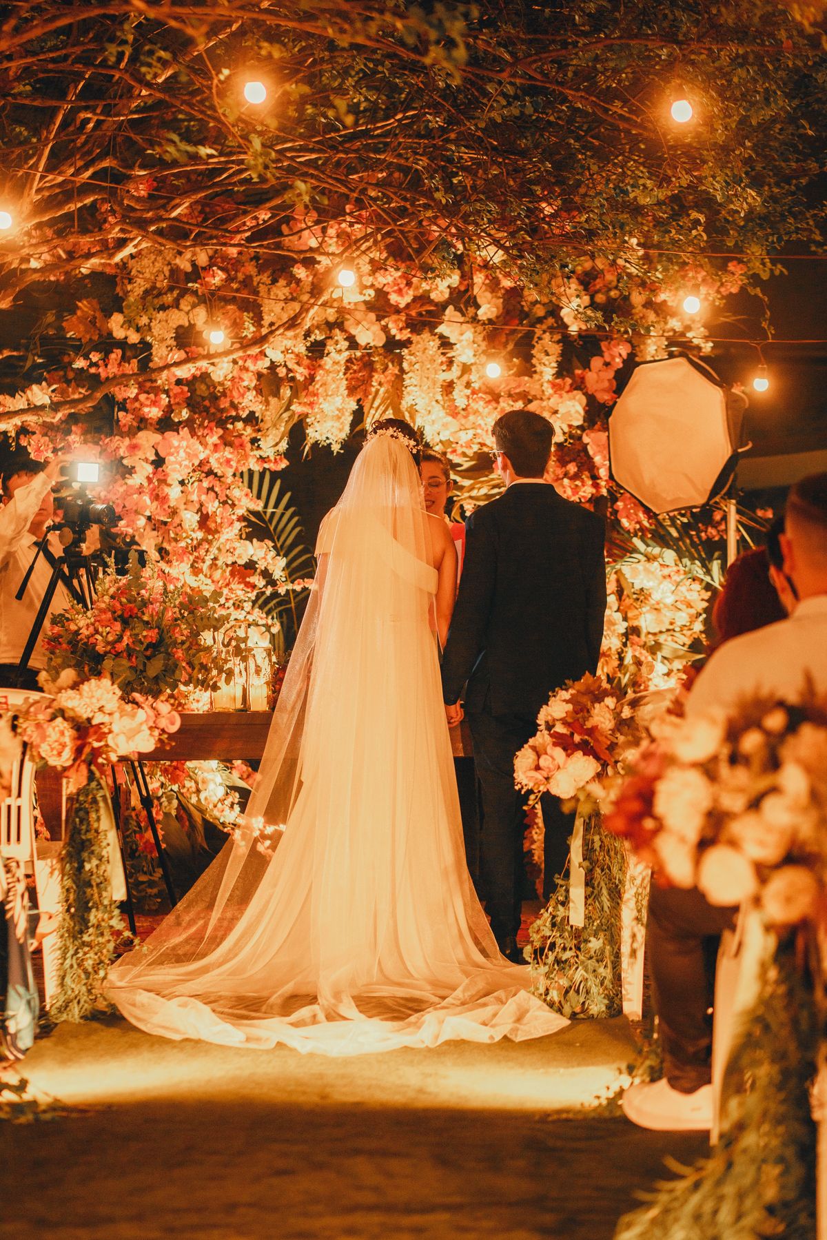 Couple at the altar under warm string lights