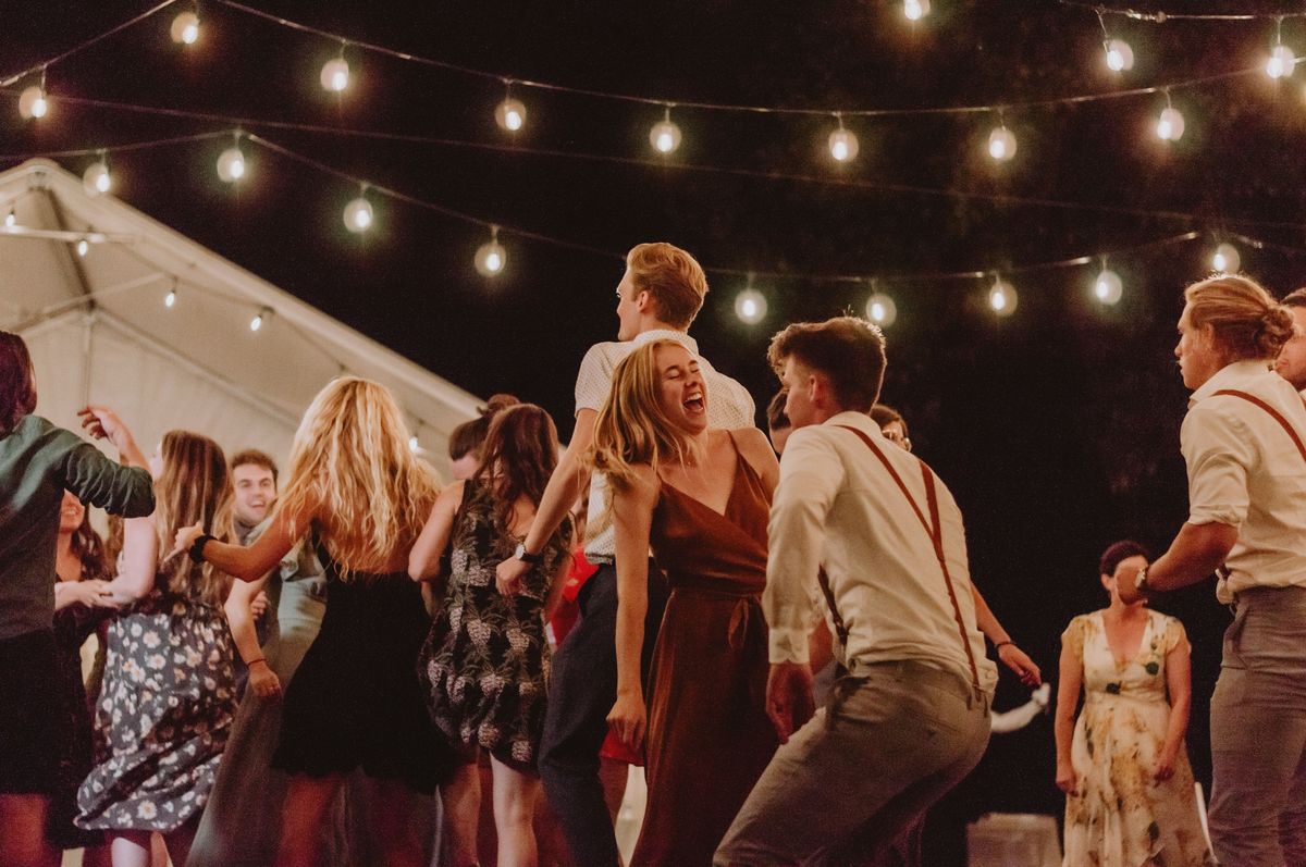 Dance floor under string lights at evening reception