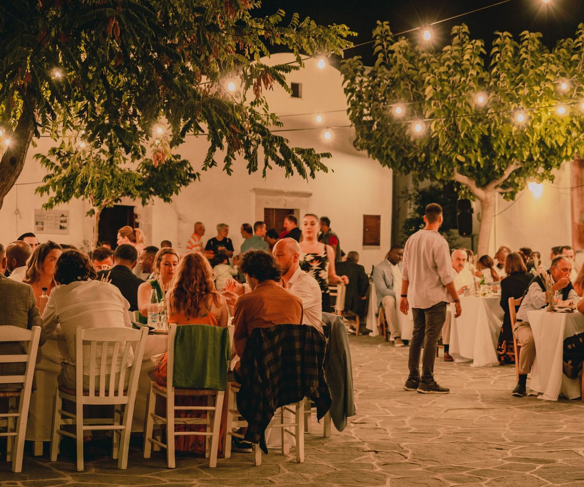 Outdoor reception dinner with candles and string lights