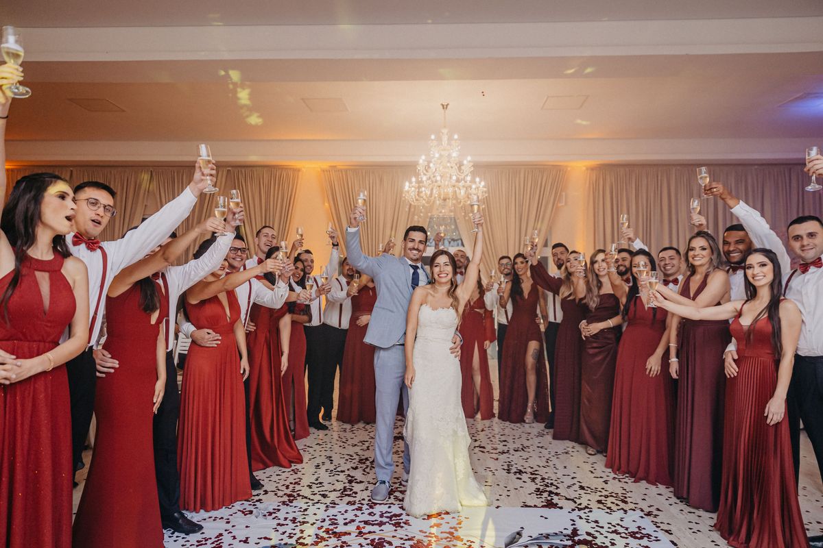 Couple toasting with wedding party at reception