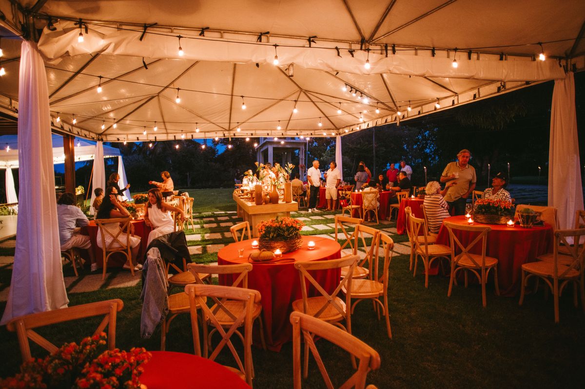 Tented reception with draped fabric and warm lighting