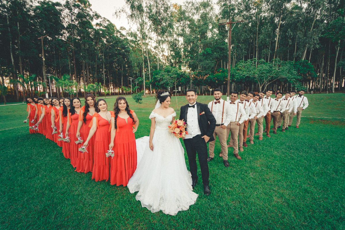 Wedding party lineup on manicured green lawn
