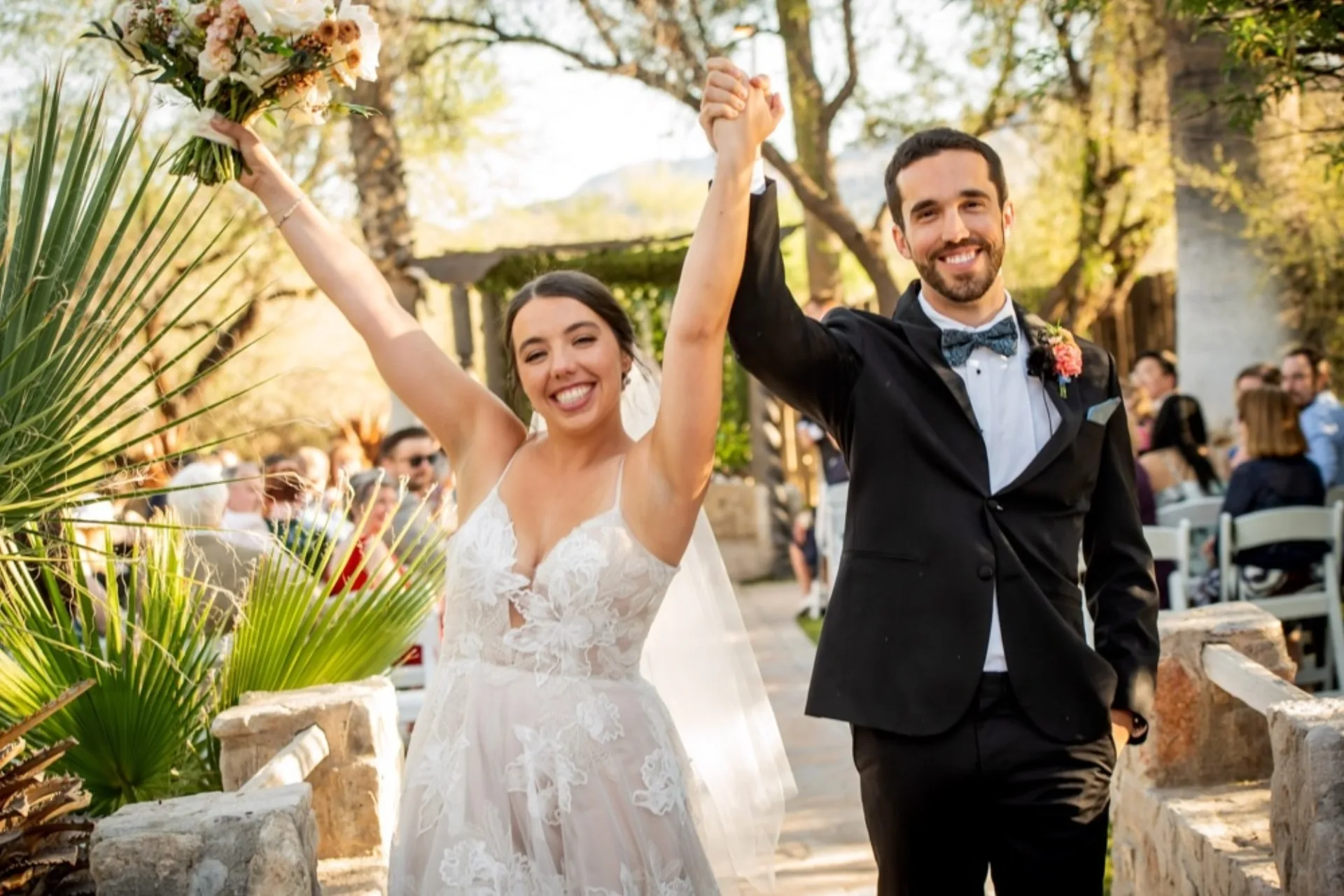 Bride and groom celebrating at indoor reception, Desert Bloom Estates Tucson wedding venue